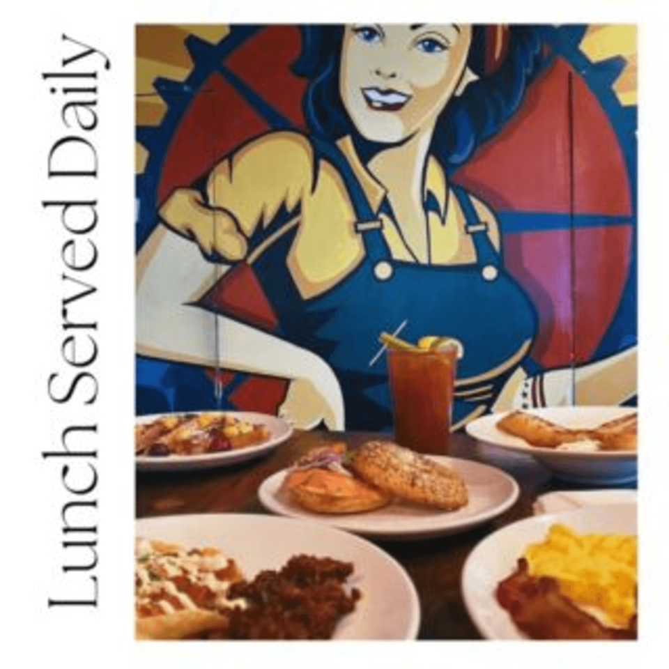 Brookland Pint's American lunch spread with various dishes and a Rosie the Riveter mural.